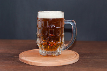 mug of beer on dark background