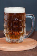 mug of beer on dark background
