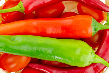 hot pepper red green closeup on a background of red tomatoes chili sauce background culinary design