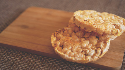 Composition with crunchy rice cakes on wooden background, side view - soft focus, healthy food