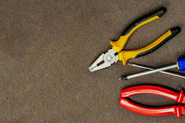 hand tool red nippers pair of iron screwdrivers fixation on brown copy space set design