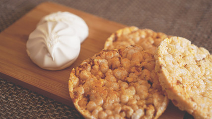 Composition with crunchy rice cakes on wooden background, side view - soft focus, healthy food