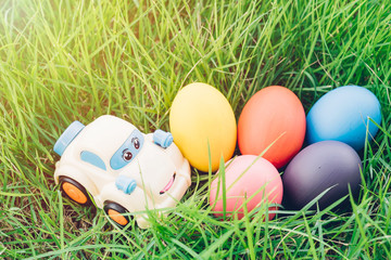 Fototapeta na wymiar Easter egg and Car on grass background,