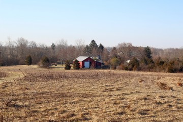 Fototapeta premium A view of the old red barn at the park in the countryside.