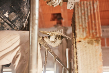 Real construction worker making a wall inside the new house.