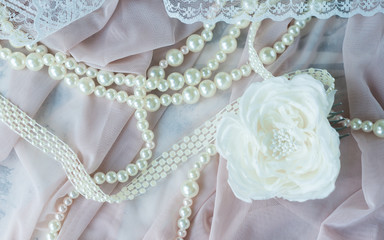 Wedding background with pearls and hair accessories on pink background