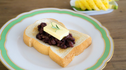 red bean toast with butter and fruits. ang butter bread. breakfast table
