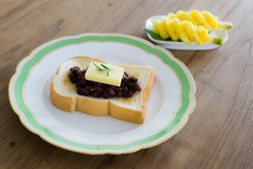 red bean toast with butter and fruits. ang butter bread. breakfast table