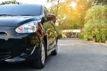 Car parked on road and Small passenger car seat on the road used for daily trips