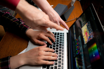 friendly team making movie using a laptop, videoediting process