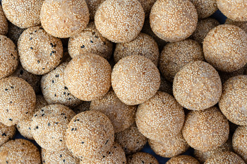 Coconut rice balls with sesame seeds is traditional Thai dessert made from rice flour and coconut milk at street food market in Thailand