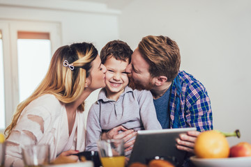Happy family preparing food in the kitchen.
