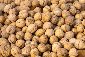 Lots of inshell walnuts on the market counter