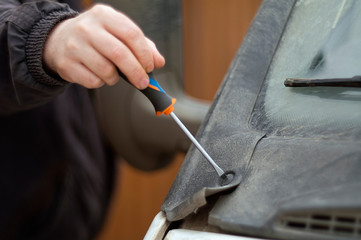 Hand fixing a car bonnet