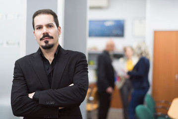 Suit office worker man with paper, suit and ear ring in work place