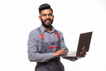 Confident indian handyman with laptop isolated on white background