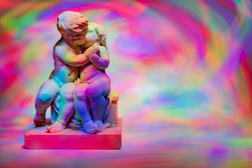 Obraz na płótnie Canvas angels kissing on a colorful background