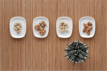 almonds cashews walnuts peeanuts plant top view with copy space for your text. flat lay. 