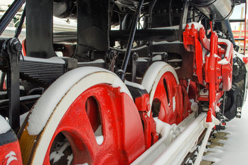 Old vintage Soviet red-black locomotive and its wheelbase