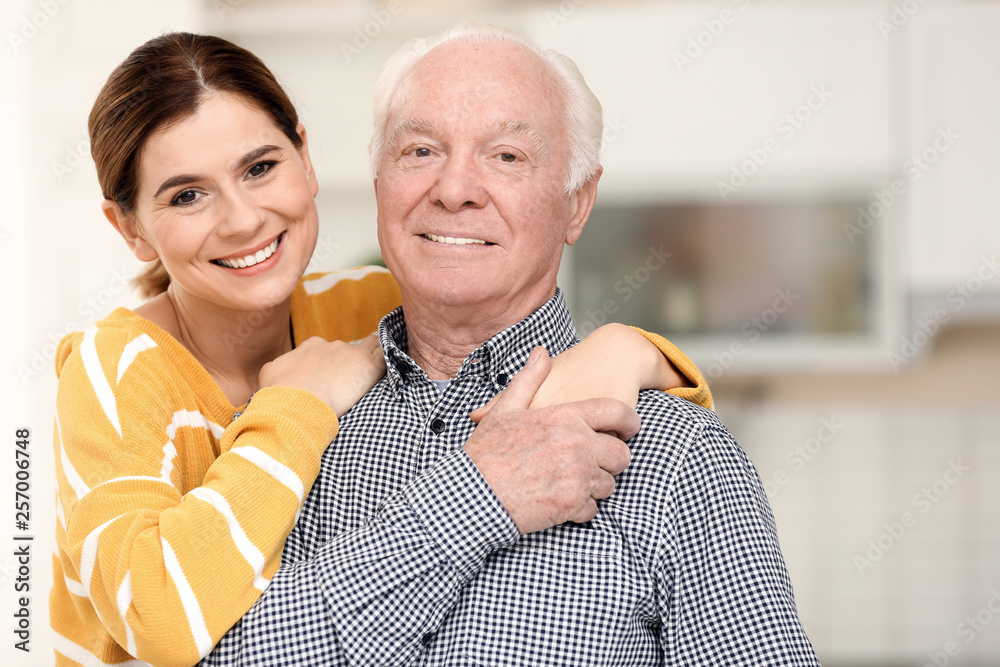 Sticker Volunteer with senior man against blurred background