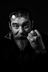 Black and white portrait of serious young man Isolated on black background and looking at camera Confident concept