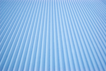 Snow velveteen on an empty ski slope.