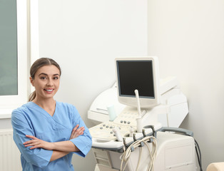 Obraz na płótnie Canvas Professional sonographer near modern ultrasound machine in clinic