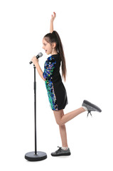 Little girl singing into microphone on white background