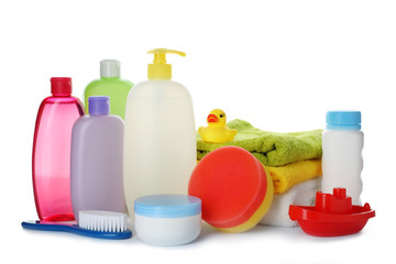 Baby cosmetic products, toys and towels on white background
