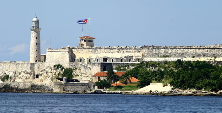 fortaleza de san carlos de la cabana with cuban flag and lighthouse in Havana Cuba