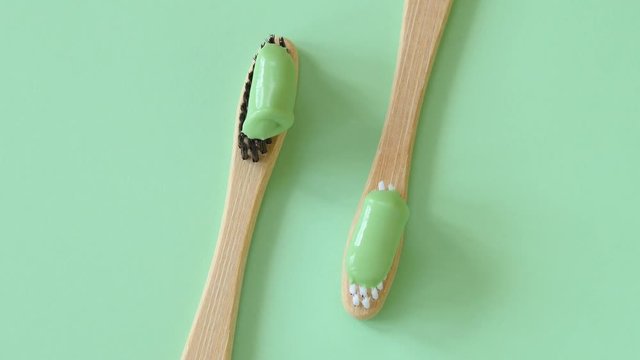 Bamboo toothbrushes with natural toothpaste rotating top view