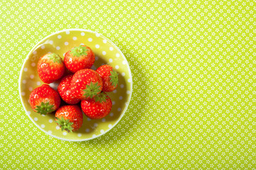 green yellow plate with red strawberries fruit with copy space like summer fruit food