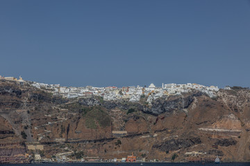 Panoramic aerial view of white building, blue sky and vivid sea in Santorini island
