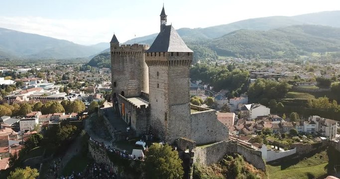 Aerial view of impressive medieval castle on rocky outcrop in French commune of Foix