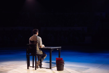 Concept. A lone Office worker sits in a dark room