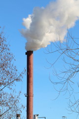 Qualmender Schornstein in einem Industriegebiet, Emissionen