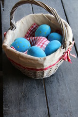 Easter eggs in basket. Traditional decoration, composition on vintage table