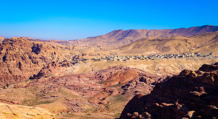 Fototapeta na wymiar Overview of Petra with modern village in background in Jordan