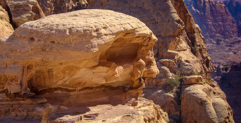 Skull like rock with mountain background at Petra in Jordan