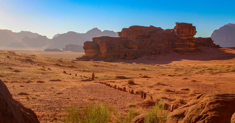 Fototapeta na wymiar Sunset in the Wadi Rum Desert in Jordan with row of stones