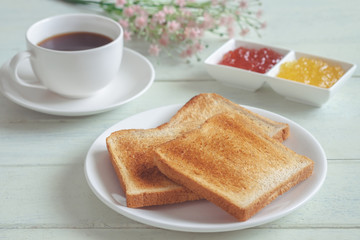 Fototapeta na wymiar Toast bread on plate with jam and coffee cup