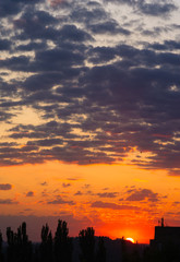 Landscape with dramatic light - beautiful golden sunset with saturated sky and clouds.