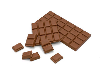 Milk chocolate bar and chocolate pieces isolated on white background