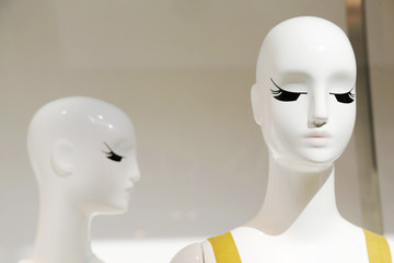 Dressed mannequins are in different stores in the Mall