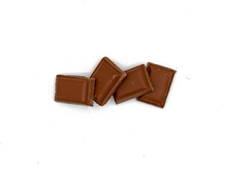 Milk chocolate pieces - isolated on white