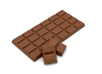 Milk chocolate bar and chocolate pieces isolated on white background