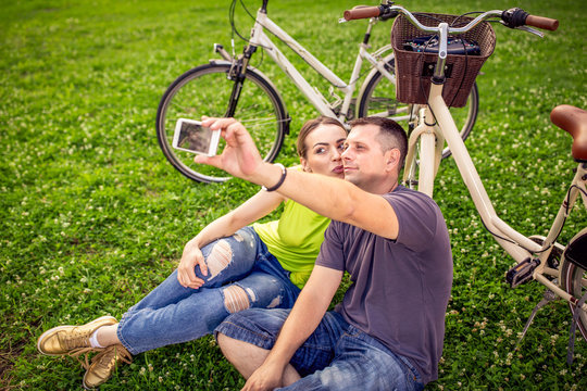 smiling young couple taking selfie.