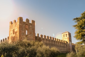 The town walls that surround Lazise, a village on the shore of Lake Garda, with sunlight...