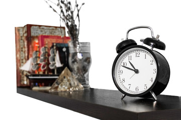 black bookshelf with clock on white background