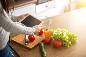 Young trendy woman cooking healthy food in the morning